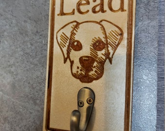 May include: Wooden dog leash hook with a laser engraved image of a dog's head and the word "Lead".