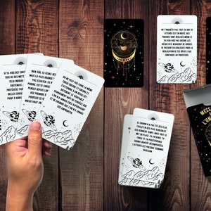 May include: A deck of cards with black and white illustrations of planets and stars. The cards have messages about the universe written on them. The box for the cards is black with gold accents and says "Messages of the Universe" on the front.