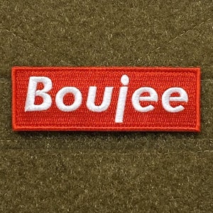 May include: A red rectangular patch with white embroidered text that reads "Boujee".