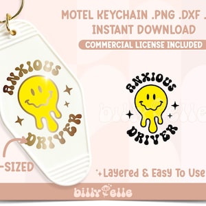 May include: A cream-colored motel keychain with a gold ring. The keychain features the words "ANXIOUS DRIVER" and a yellow smiley face with dripping details. The text "PRE-SIZED" is also visible.