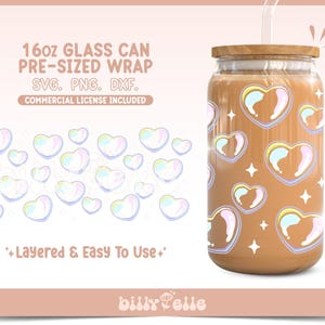 May include: A 16oz glass can with a wooden lid, filled with a brown liquid, and decorated with heart-shaped designs. The hearts have a rainbow-colored outline. The image also includes the text "16oz GLASS CAN PRE-SIZED WRAP SVG. PNG. DXF. COMMERCIAL LICENSE INCLUDED".