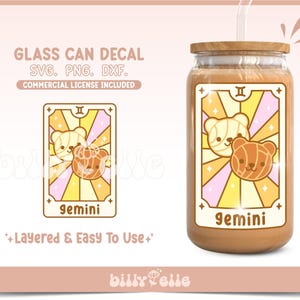 May include: A glass can decal featuring a yellow and pink tarot card with two cartoon bears. The card says "gemini" and has a yellow star on each corner. The decal is layered and easy to use.