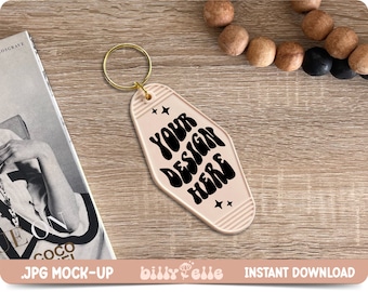 May include: A pink motel key tag with a gold key ring. The tag has the text "YOUR DESIGN HERE" in black, wavy letters.