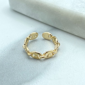 May include: A gold-colored adjustable ring with a chain link design. The ring is open at the top and features a series of oval-shaped links. The ring is set against a white background.