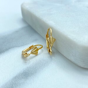 May include: A pair of gold-tone earring clips with a fan-shaped design.