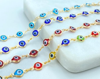 May include: Five gold chains with evil eye charms in different colors, including blue, red, green, and yellow. The chains are laid out on a white surface.