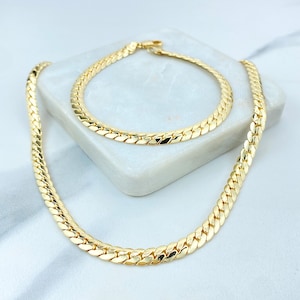 May include: A gold chain necklace and bracelet set featuring a curb chain design. Both the necklace and bracelet are made from a thick, chunky chain.