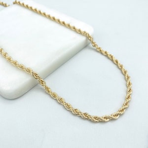 May include: A gold rope chain necklace. The chain is made of a thick, twisted rope design.