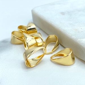 May include: A group of gold-colored metal pendant bails, designed to attach a pendant to a chain or cord.