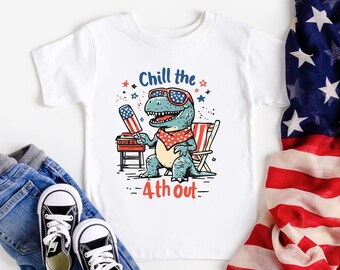 May include: White t-shirt with a cartoon dinosaur wearing sunglasses and holding a popsicle. The dinosaur is sitting in a beach chair with a grill in the background. The text "Chill the 4th out" is printed on the shirt.