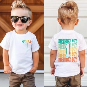 a little boy wearing a birthday shirt and sunglasses