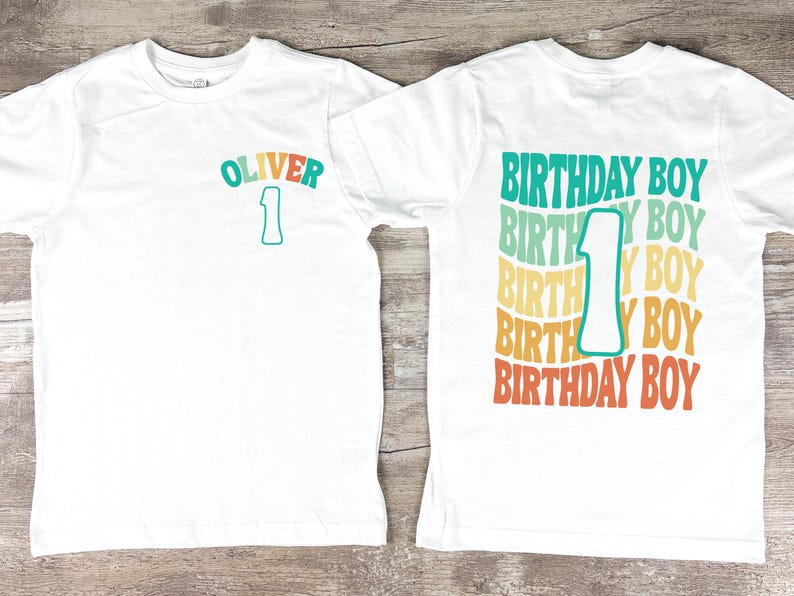 a white birthday shirt with the number one on it