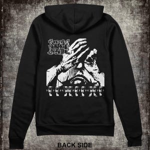 May include: Black zippered hoodie with a white graphic print of a hand covering a face with the text "NAPALM DEATH" above the hand and a row of eyes below the hand.