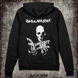 May include: Black hooded sweatshirt with a white graphic print of a skeleton holding a book that says "Protect and Survive". The text "Discharge" is printed above the skeleton.