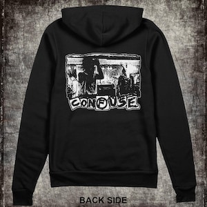 May include: Black hooded sweatshirt with a white graphic print of a band called "CONFUSE" on the back. The graphic features a band performing on stage.