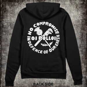 May include: Black hooded sweatshirt with a white circle graphic on the back. The graphic features a wrench and a thistle with the text "No Compromise In Defence Of Our Earth Oi Polloi".