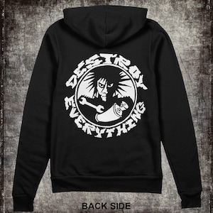 May include: Black hooded sweatshirt with a white graphic on the back. The graphic features a stylized face, a wrench, and a spray paint can inside a circle with the words "DESTROY EVERYTHING". The text "BACK SIDE" is at the bottom.