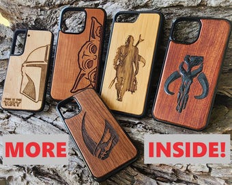 May include: Five rectangular phone cases with black frames and wood-grain back panels featuring laser-engraved designs. The designs include a helmet, a small creature, a standing figure with a spear, and skull motifs. One case includes the text THIS IS THE WAY.