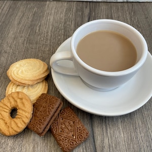 Tea and Biscuits gift  - Two tins of tea, two packets of genuine British biscuits and a Union Jack napkin. A treat from Great Britain.