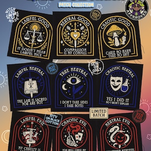 May include: A selection of black fabric patches with diverse designs and text. The patches feature gold, blue, and red foil accents. Text includes "Lore & Disorder," "Lawful Good," "Neutral Good," "Chaotic Good," and other alignment-based phrases.