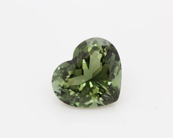 May include: A heart-shaped green gemstone with facets.