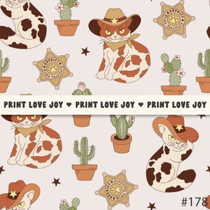 May include: A seamless pattern featuring a cartoon cat wearing a cowboy hat and bandana, cacti, stars, and a sheriff's badge with the text "Home Territory". The background is a light pink colour.