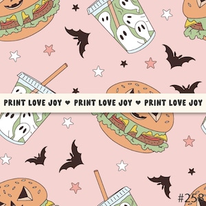 May include: A repeating pattern on a pink background featuring burgers, ghost-filled drinks, bats, and stars. The text "PRINT LOVE JOY" is repeated across the image. The design has a Halloween theme.