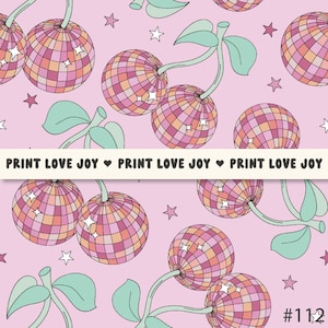 May include: A pink background with a repeating pattern of cherries with disco ball designs. The cherries have green stems and leaves. The background is also decorated with small white stars. The text "PRINT LOVE JOY" is repeated across the bottom of the image.