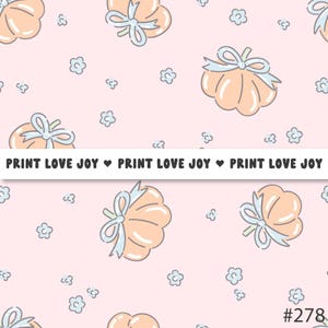 May include: A repeating pattern on a pink background featuring cartoon pumpkins with light blue bows and small blue flower shapes. The text "PRINT LOVE JOY" is repeated across the image.