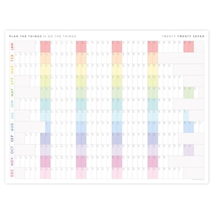 May include: A wall calendar for the year twenty twenty seven with the text PLAN THE THINGS // DO THE THINGS at the top left and TWENTY TWENTY SEVEN at the top right. The grid features months in rows and days in columns with vertical colour bands.
