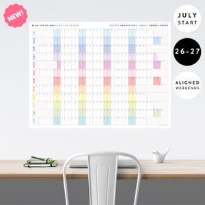 May include: A wall calendar titled PLAN THE THINGS // DO THE THINGS for twenty twenty-six and twenty twenty-seven. It features a July start, aligned weekends, and a grid with months listed vertically in colors and days across the top.