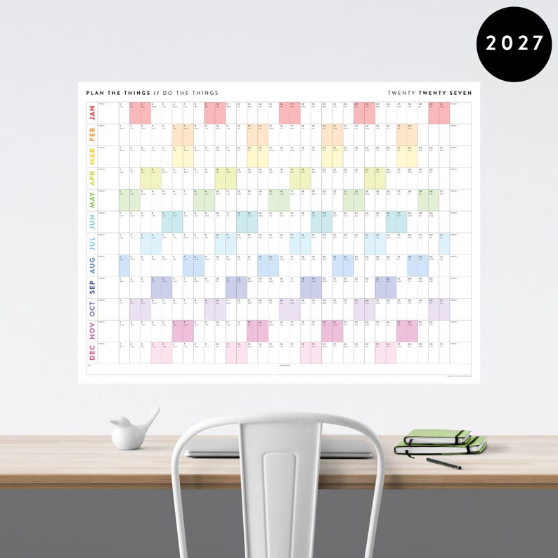 May include: A large 2027 wall calendar with a grid layout and colour-coded months. The calendar has the text "PLAN THE THINGS // DO THE THINGS" and "TWENTY TWENTY SEVEN". Months are labelled vertically on the left side.
