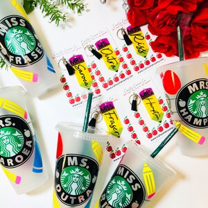 May include: Set of six personalized teacher gift tumblers with a Starbucks logo, pencils, and apples. The tumblers are frosted and have a variety of teacher names, including Miss Fraser, Mrs. Hampton, and Ms. Dutra.