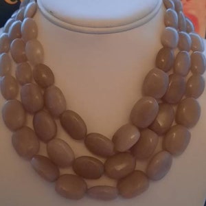 A genuine vintage art deco genuine tested bakelite beaded multistrand statement necklace in apple juice/gold translucent colour. Lovely.