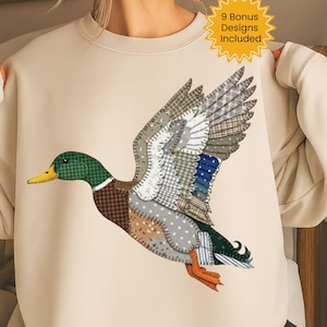 May include: A beige sweatshirt featuring a detailed appliqué of a flying duck. The duck is composed of various fabric patterns in shades of green, brown, blue, and gray. The text "9 Bonus Designs Included" is in a yellow starburst.