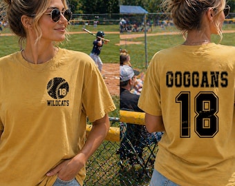 May include: Mustard yellow t-shirt with a baseball graphic on the front and the name "Goggans" and the number "18" on the back. The front graphic includes a baseball with the number "18" and the word "Wildcats".