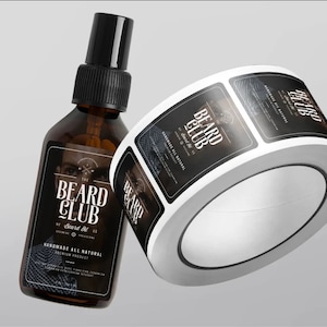 May include: A roll of black and white labels with the text "The Beard Club" and "Beard Oil" printed on them. The labels are designed for a bottle of beard oil.