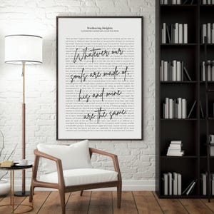 May include: A framed print of text from Wuthering Heights, with the quote "Whatever our souls are made of, his and mine are the same." The print is in a black frame, hanging on a white brick wall. A wooden chair and bookshelf are in the room.