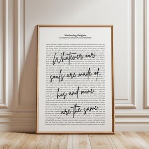 May include: A framed print featuring text from "Wuthering Heights" by Catherine Earnshaw. The quote "Whatever our souls are made of, his and mine are the same" is highlighted in a stylish font. The print is in black and white.