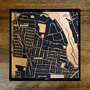 Pode incluir: Um mapa de Jesmond, Newcastle upon Tyne, Inglaterra, em folha de ouro. O mapa é emoldurado em preto e apresenta nomes de ruas e pontos de referência. O mapa é assinado "@Toonfoil" no canto inferior direito.