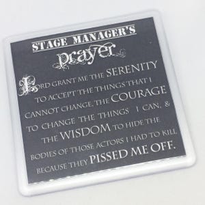 Puede incluir: Un posavasos blanco y negro con el texto "Stage Manager's Prayer" y una oración humorística sobre la serenidad para aceptar las cosas que no se pueden cambiar, el coraje para cambiar las cosas que se pueden, y la sabiduría para esconder los cuerpos de esos actores que te hicieron enfadar.