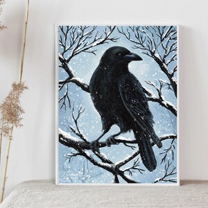 May include: A black crow perched on a snow-covered branch in a wintery scene. The crow is facing to the right and has its wings folded. The background is a light blue with white snow falling.