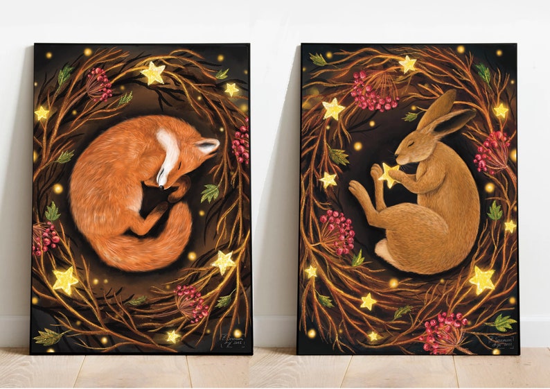 May include: Two framed illustrations of a fox and a hare sleeping in a wreath of branches with glowing stars. The fox is curled up in a ball, while the hare is holding a star in its paw. Both animals are surrounded by a dark background with red berries and leaves.