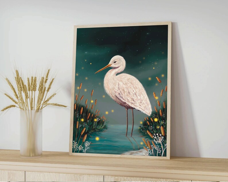 May include: A white egret stands in a dark blue pond with green reeds and glowing yellow fireflies. The egret has a long, thin beak and long, slender legs. The background is a dark blue sky with a few stars.