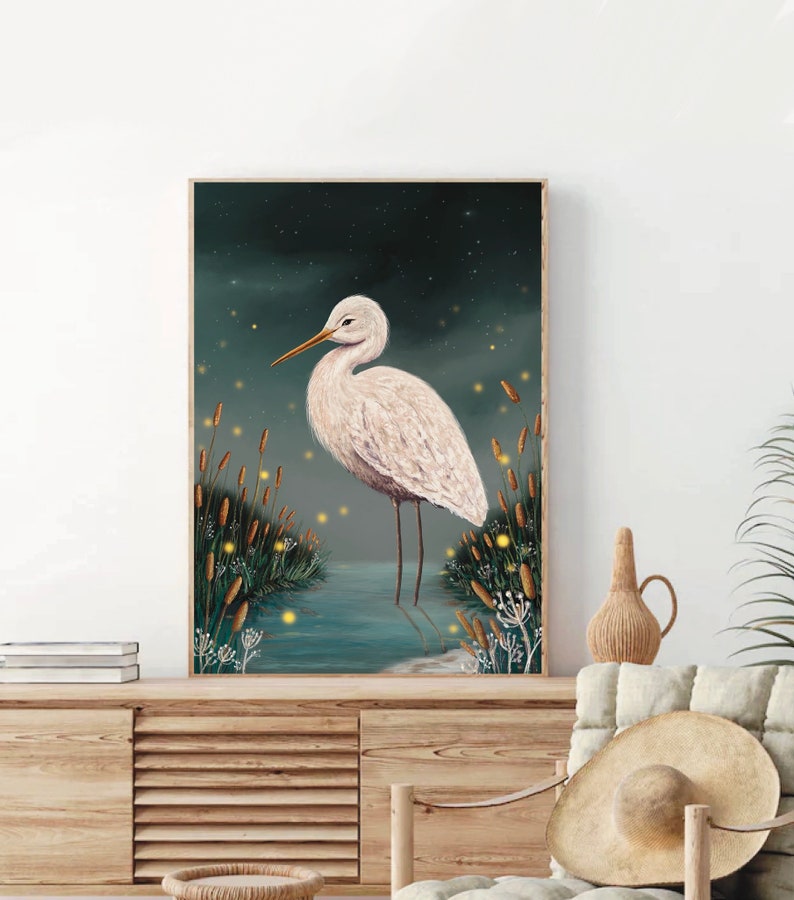 May include: A white egret stands in a body of water with tall green reeds and glowing yellow fireflies in the background. The egret has a long, thin neck and a long, thin beak. The water is a dark blue color and the reeds are a dark green color. The fireflies are a bright yellow color.