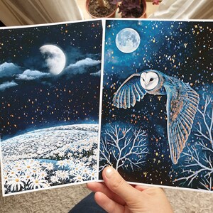Puede incluir: Dos tarjetas impresas con un tema de cielo nocturno. La primera tarjeta muestra un campo de margaritas blancas bajo una luna creciente y un cielo estrellado. La segunda tarjeta muestra un b&uacute;ho chico volando frente a una luna llena y un cielo estrellado.