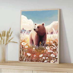May include: A framed art print featuring a brown bear standing in a field of white wildflowers. The bear is the focal point, set against a backdrop of a blue sky and fluffy clouds. The artwork has a soft, painterly style.