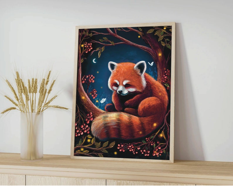 May include: A framed art print featuring a red panda resting on a tree branch. The artwork has a dark blue background with a crescent moon, berries, and glowing lights. The red panda has a fluffy tail and white markings.