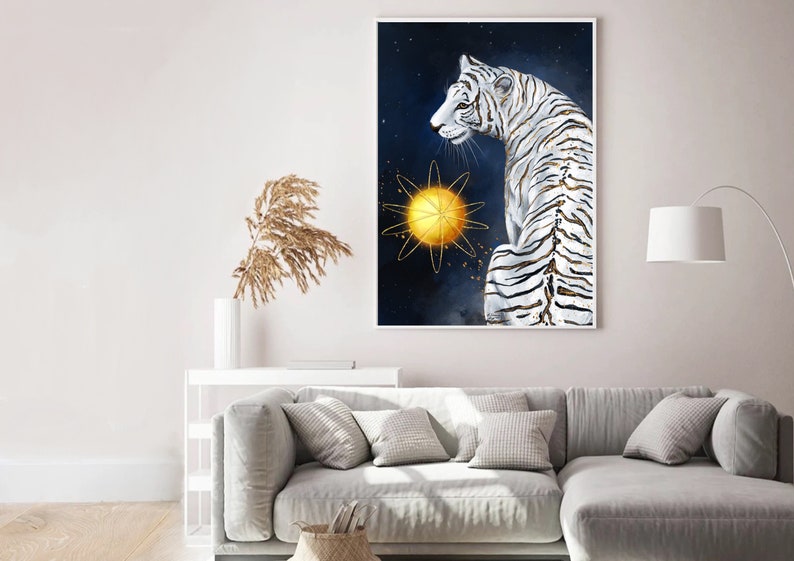 May include: A white tiger with gold stripes sits against a dark blue background with a gold star in the centre. The tiger is looking to the left of the image.