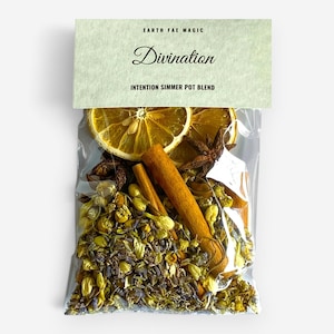 May include: A clear plastic pouch containing a simmer pot blend of dried orange slices, star anise, cinnamon sticks, chamomile flowers, and lavender buds. The top label is light green with the text Earth Fae Magic, Divination, and Intention Simmer Pot Blend.